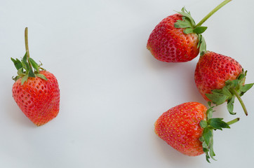 Red Strawberries On White Fabric Background.