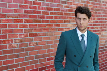 Young modern business man smiling standing outdoor with copy space on the left side of the picture