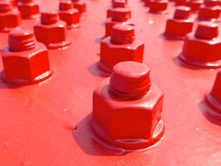 Closeup of big bolt and nut on bridge