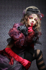 Fashion shot of woman in doll style. Creative make-up.Fantasy dr