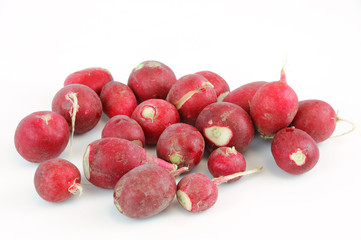 small red radishes on white background