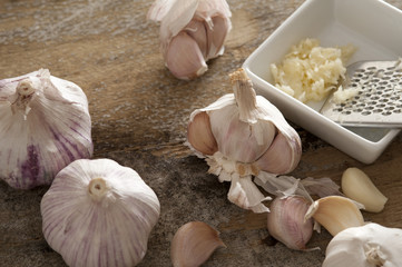 Fresh garlic bulbs and grater