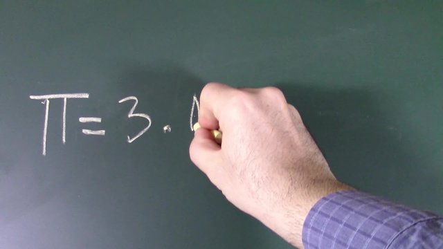 Man's hand writing with chalk on blackboard the  approximate value of the pi number followed by a couple of commonly known decimals