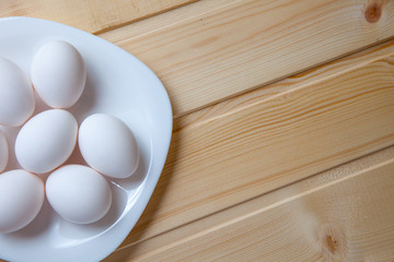 White eggs on a wooden table