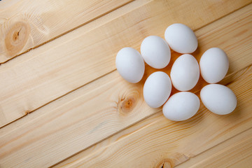 White eggs on a wooden background
