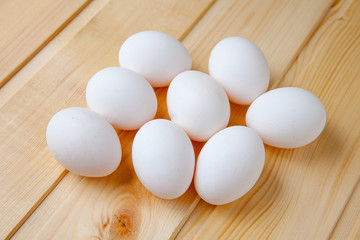 White eggs on a wooden table