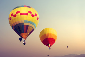 Naklejka premium Colorful hot air balloons flying on sky with fog - retro filter effect style