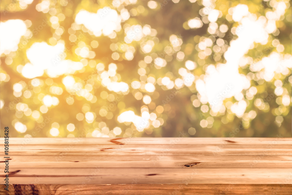 Wall mural top of wood table with blurred bokeh nature background - empty ready for your product display or mon