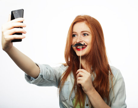  Smiling cheerful blond-haired woman doing selfie