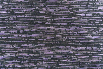 the texture of black fabric with violet horizontal touches