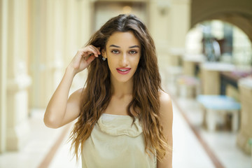 Fototapeta premium Portrait close up of young beautiful brunette woman in beige dre