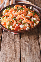 Greek cuisine: shrimp Saganaki on a plate. vertical
