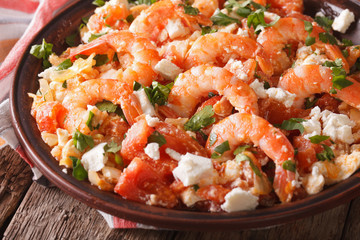 Greek cuisine: shrimp Saganaki close-up on a plate. horizontal
