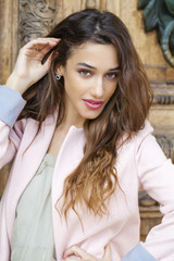 Beautiful young woman in pink coat