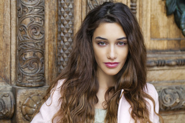 Fototapeta premium Beautiful young woman in pink coat