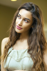 Fototapeta premium Portrait close up of young beautiful brunette woman in beige dre