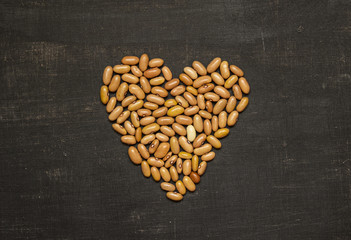 Heart of seed beans on a black background
