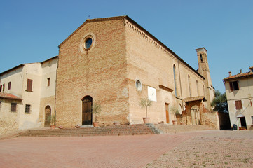 large stone church with a sundial and a tower
