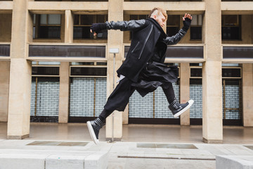 Stylish bearded man jumping in the street