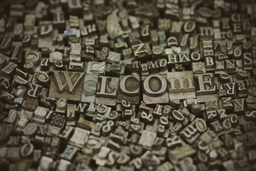 Close up of typeset letters with the word Welcome