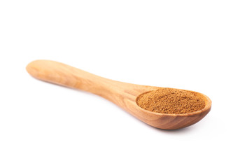 Wooden spoon full of cinnamon