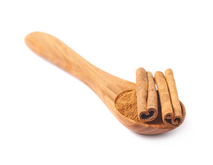Wooden spoon full of cinnamon