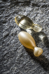 Gel capsules on a stone background
