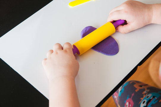 Child Playing With Colorful Clay Molding Different Shapes