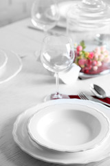 Table set at restaurant on light background