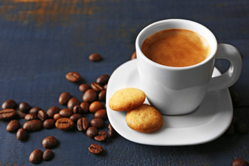 Cup of coffee on wooden table background
