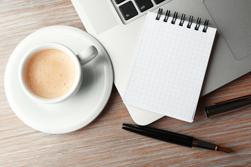 Empty  notebook on laptop keyboard, on light background