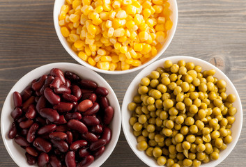 Red beans, green peas and sweet corn in white bowls
