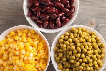 Red beans, green peas and sweet corn in white bowls