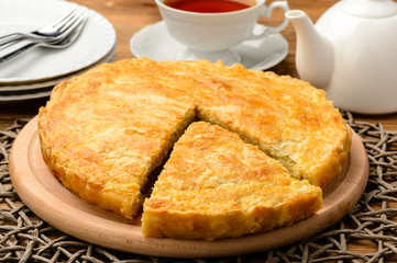 Pie with minced meat on wooden background.