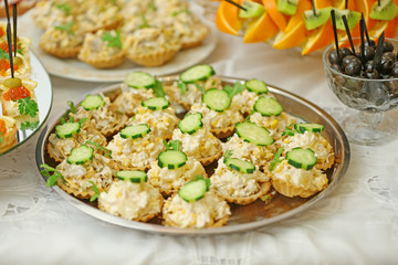 Dish with assorted snacks on a table