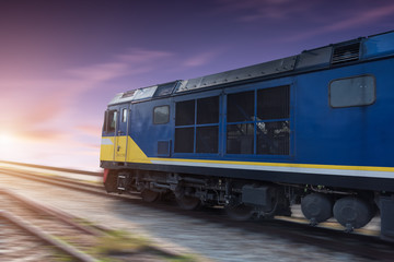 Fast freight blue train at sunset