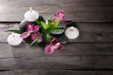 Spa still life with beautiful flower and candlelight on wooden background