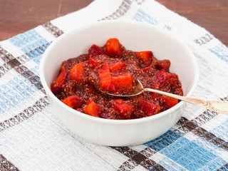 Chia puding with strawberry juice and strawberries in a bowl
