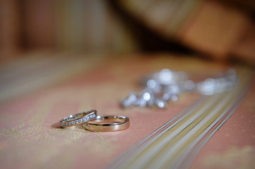 two gold rings on carpet in wedding day
