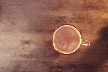 Glass of beer on wooden table