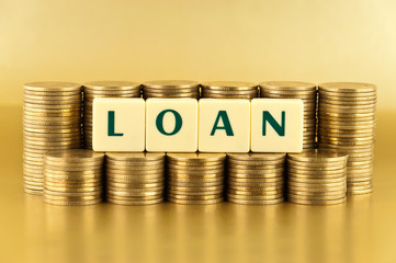 the letters LOAN with stacks of coins