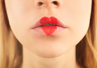 Fototapeta premium Sexy lips with coral heart shape paint, closeup