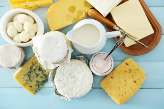 Set of fresh dairy products on blue wooden table, close up