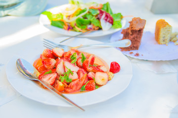 Spicy salad with strawberry , tomato and coriander
