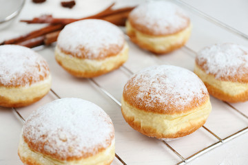 Fresh homemade donuts with powdered sugar, close up