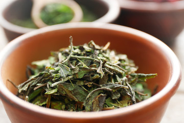 White tea in a wooden bowl, close up