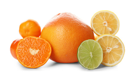 A heap of mixed citrus fruit sliced and unpeeled isolated on a white background, close up