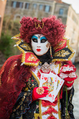 Fototapeta na wymiar Venice - February 6, 2016: Colourful carnival mask through the streets of Venice and in St. Mark's Square during celebration of the most famous carnival in the world. 