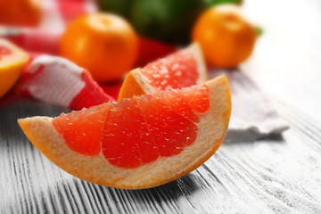Piece of grapefruit on wooden light background