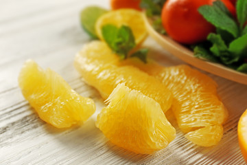 Set of different citrus fruit on light wooden background